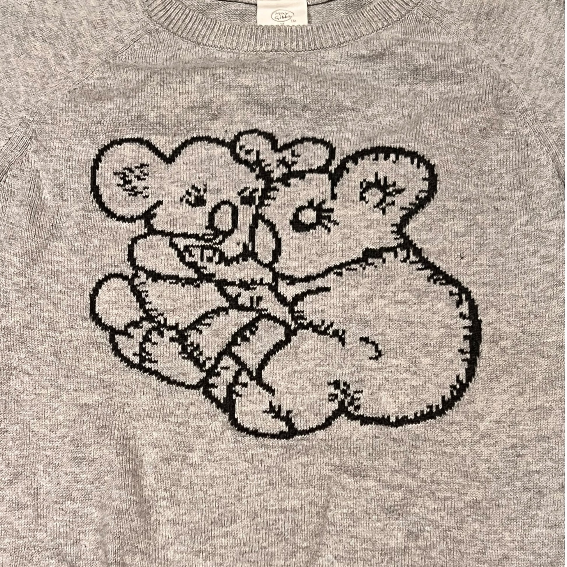 Gray sweater with a embroidered bear design on a plain background